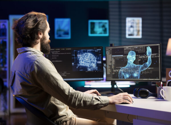 Self aware AI gaining humanoid form inside cyberspace, waving hand, saluting software engineer. Artificial intelligence becoming sentient, greeting IT expert at desk, AI singularity concept