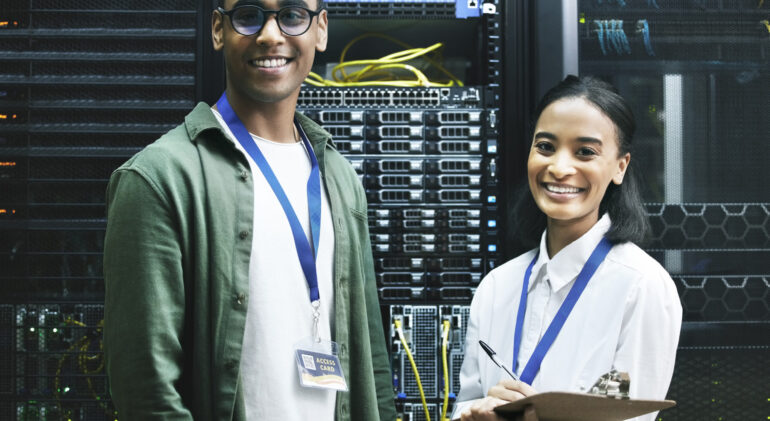 No virus, no problem. Shot of two technicians working together in a server room