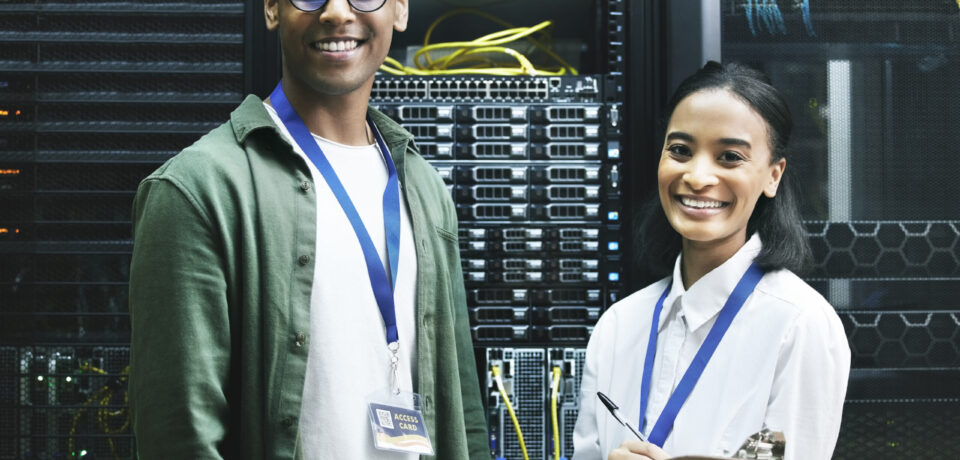 No virus, no problem. Shot of two technicians working together in a server room