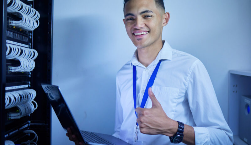 Man, thumbs up and server room on computer in cybersecurity, IT cables and hardware or data safety .